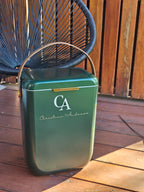 Green cooler box with brown handle on outside deck