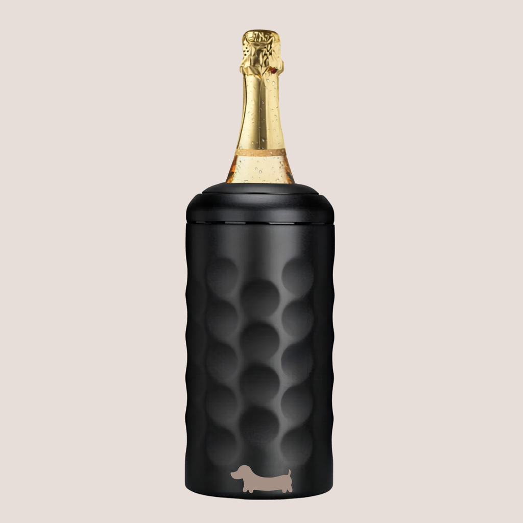 Customised sausage dog on a black textured wine cooler with a champagne bottle inside on a beige background 